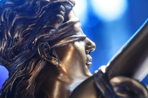A close up of the blindfold on the lady justice.