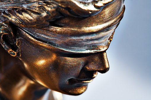 A close up of the blindfold on the lady justice.