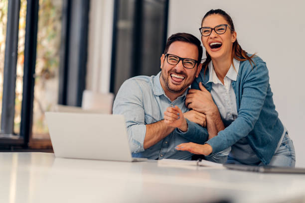 istock Business couple having fun at office 1256194406