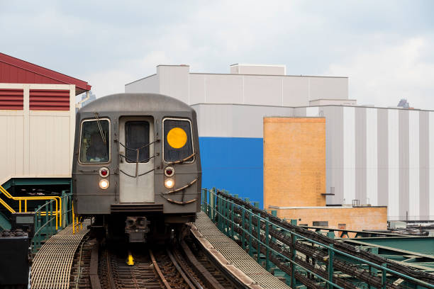 Elevated subway train entering station in Queens,