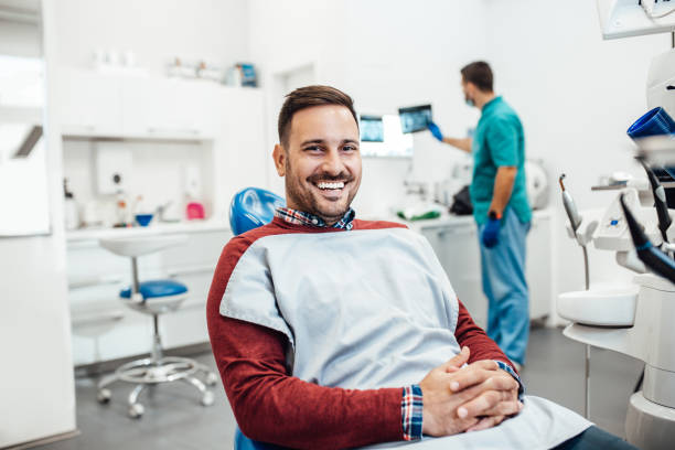 Dental treatment Young good looking man having dental treatment at dentist's office. dentist stock pictures, royalty-free photos & images