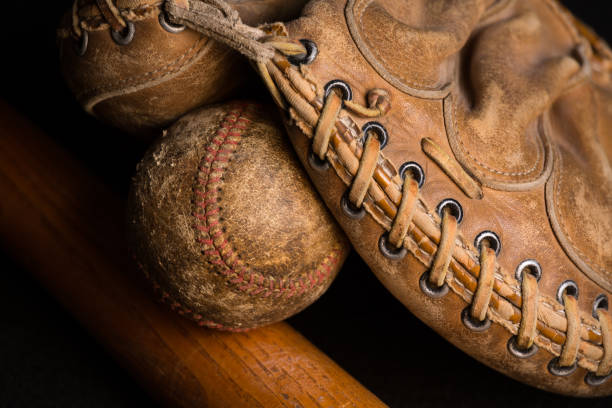 istock Catchers mitt with old baseball and bat. 1256197528