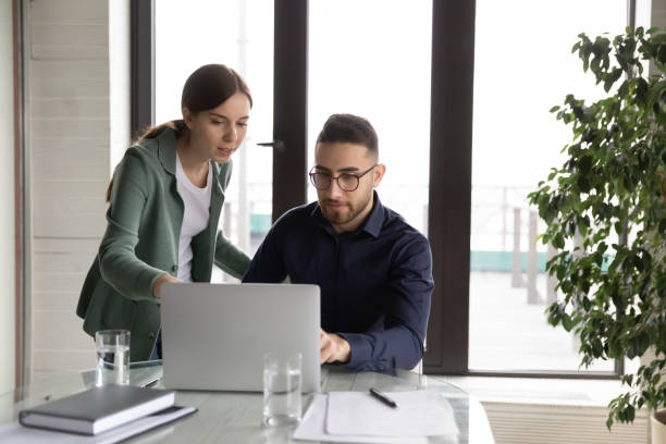 istock Multiethnic colleagues work together on laptop in office 1256199236
