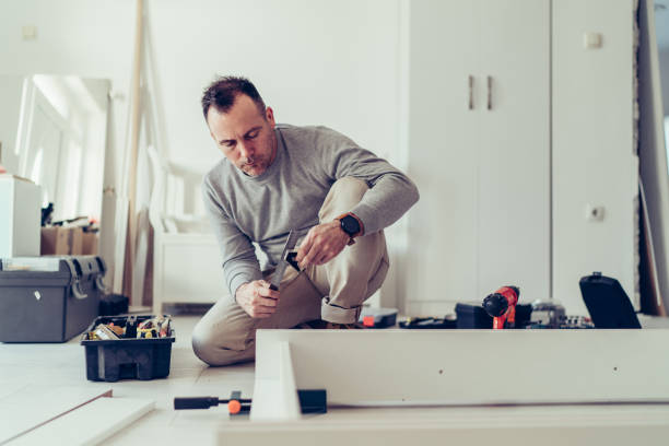 istock Man assembling a wardrobe for his new apartment 1256199265