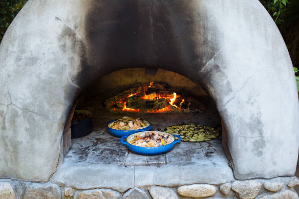 Food in Adobe Oven Rustic cooking in clay oven stove oven adobe outdoors stock pictures, royalty-free photos & images