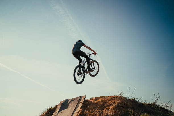 istock Extreme mountain biker jumping and performing aerial maneuvers 1256200861