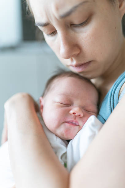 istock New mom snuggles her newborn daughter 1256201833