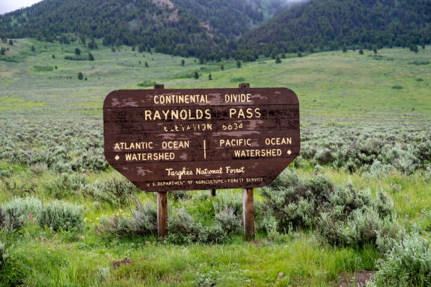 divisão continental - raynolds pass sinal na floresta nacional targhee na fronteira de idaho e montana ao longo da rodovia 87 - continental divide - fotografias e filmes do acervo