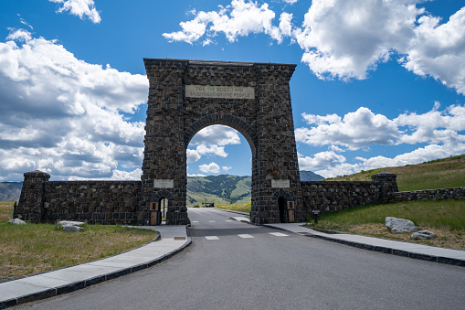Gardiner, Montana - July 1, 2020: The famous Roosevelt Arch at the North Entrance of Yellowstone National Park on a sunny day