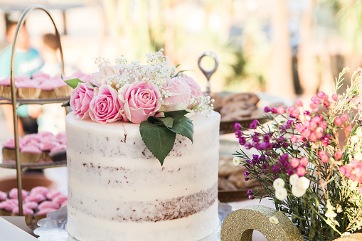 Close up on Wedding cake and bouquet on table