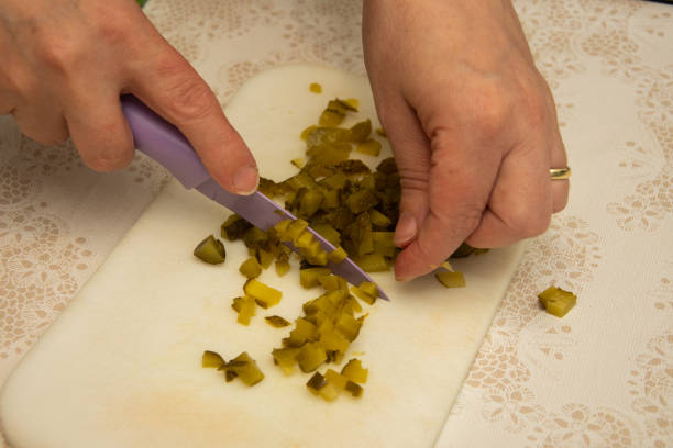 istock Housewife hands cutting pickles cucumbers 1256206598