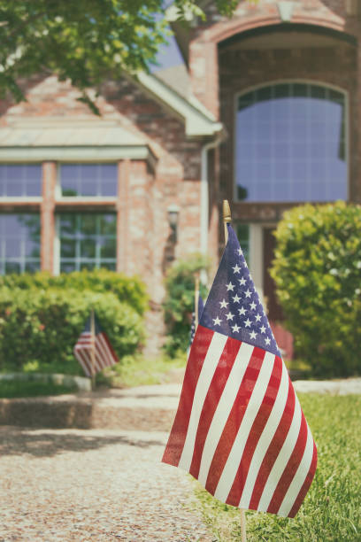 istock American flags displayed in the front of a southern home 1256206964