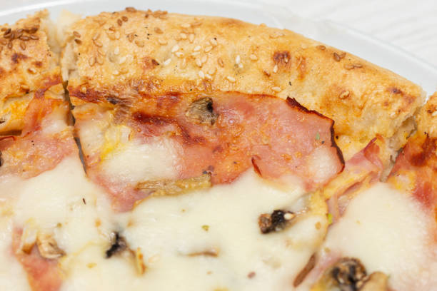 istock pizza Di Roma  with ham and sesame 1256211700