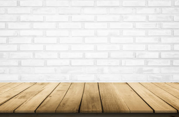 istock Empty wooden table top on white brick wall background, Design wood terrace white. Perspective for show space for your copy and branding. Can be used as product display montage. Vintage style concept. 1256213542