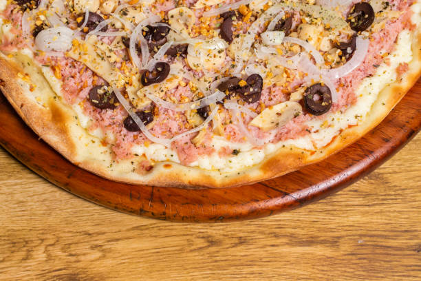 istock pizza with onion, ham, olive and mushroom. 1256219593