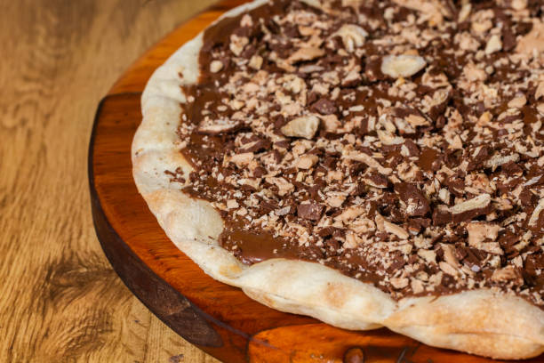 istock sweet pizza, chocolate pizza covered with chopped chocolate candy. 1256219712