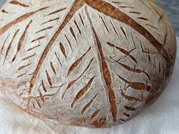 istock Close-up of Scored Sourdough Bread 1256226378