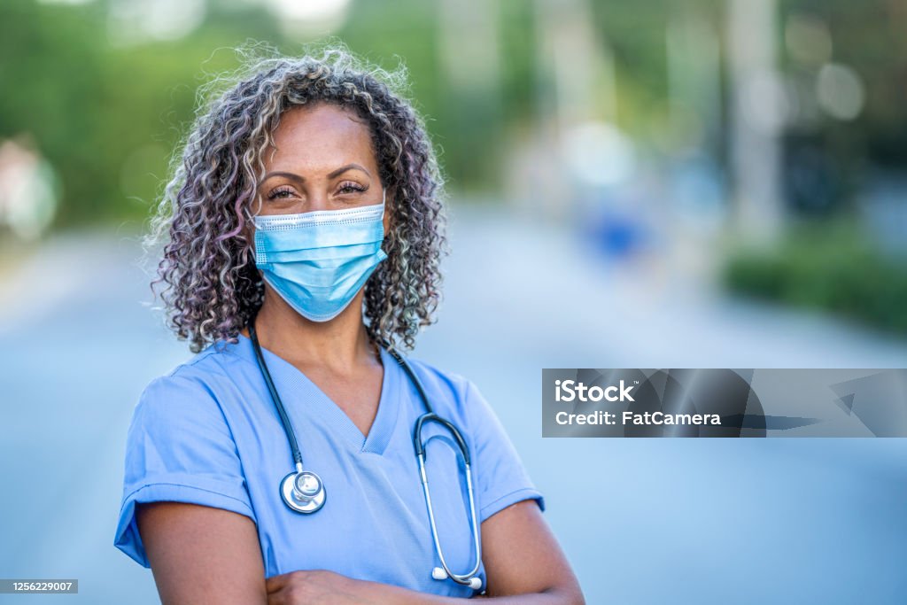 African American medical professional Portrait of an African American nurse wearing a protective face mask to avoid the transfer of germs during the COVID-19 outbreak. Nurse Stock Photo