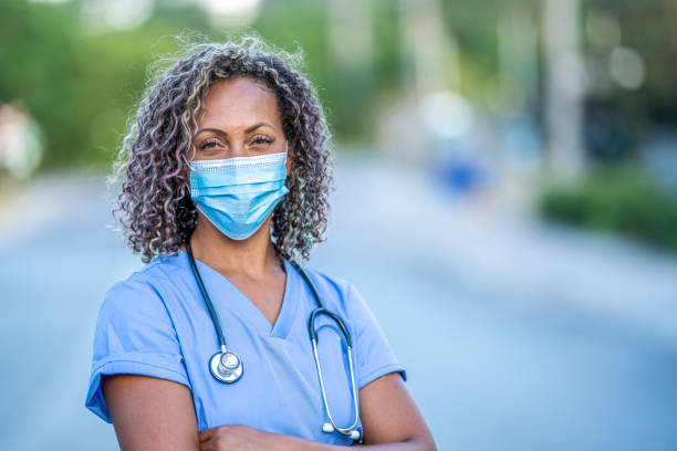 African American medical professional Portrait of an African American nurse wearing a protective face mask to avoid the transfer of germs during the COVID-19 outbreak. n95 face mask photos stock pictures, royalty-free photos & images