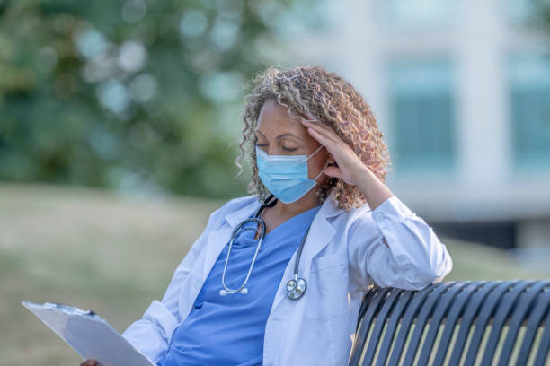 istock African American doctor sitting on a bench 1256229039