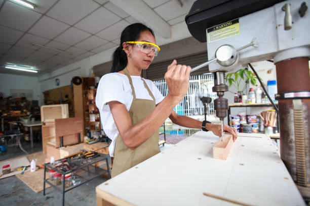 istock Small Business - A Woman Carpenter Using A Drilling Machine 1256231992