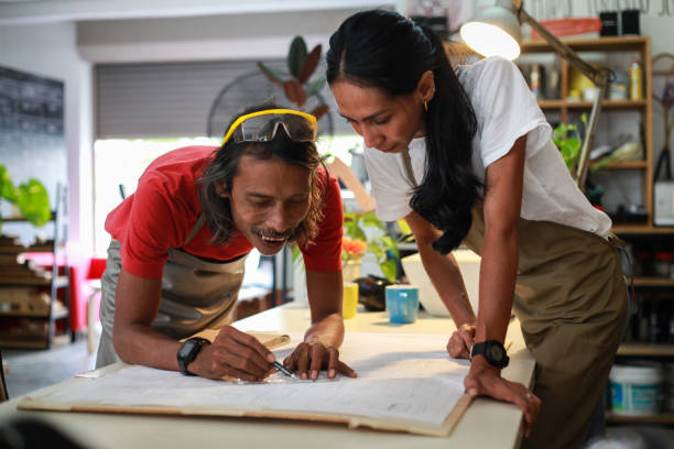 istock Small Business - Carpenters Having A Discussion at Their Workshop 1256232033