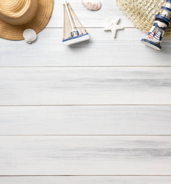 istock Top view summer rustic blue lighthouse and seashell decorate on white wooden table with sunlight shade 1256233649