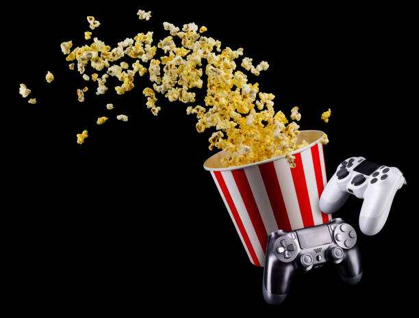 istock Flying popcorn and video game joystick gamepad isolated on a black 1256238500