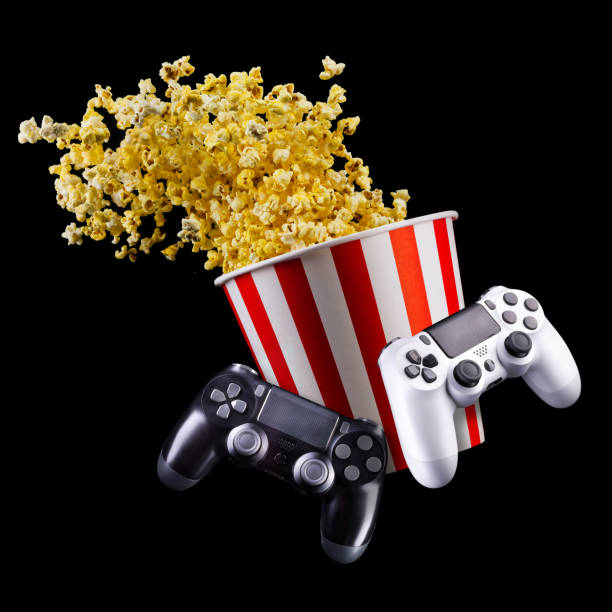 istock Flying popcorn and video game joystick gamepad isolated on a black 1256238525