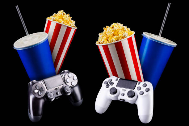 istock Flying popcorn, cup of soft drink and video game joystick isolated on black 1256238552