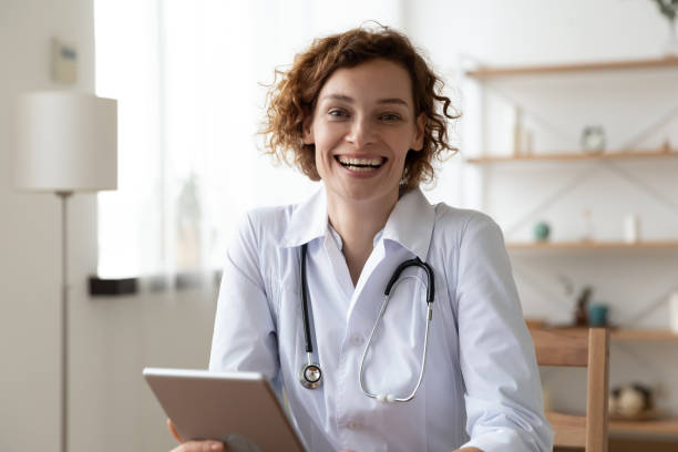 istock Portrait of smiling female doctor using tablet 1256240247