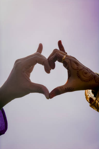 istock A Man and Woman Posing hands Like Heart Shape. 1256245913