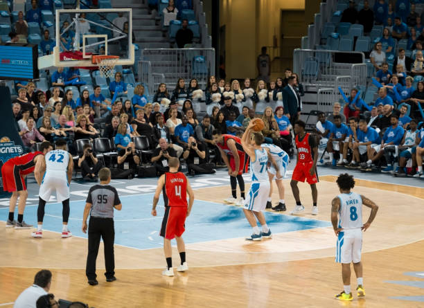 istock Basketball player shooting ball to basket 1256247194