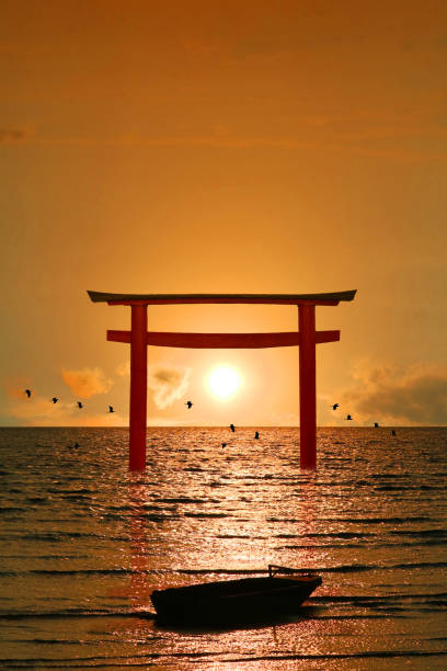 istock reflection torii sunset orange cloud on sky and birds flying on the sea vertical view 1256247798