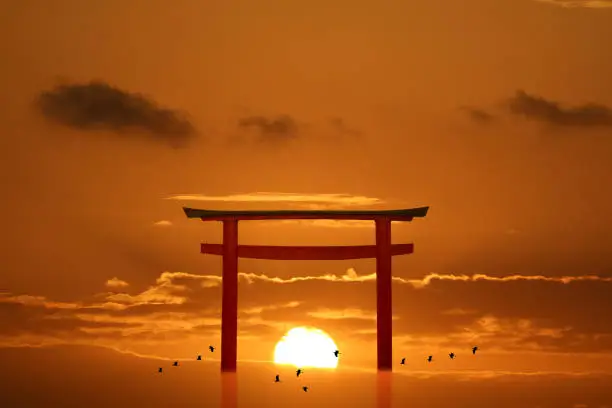 torii sunset orange cloud on sky and birds flying on the sea