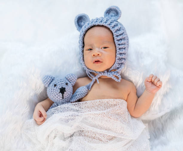 istock newborn baby in bear hat on fur bed 1256248358