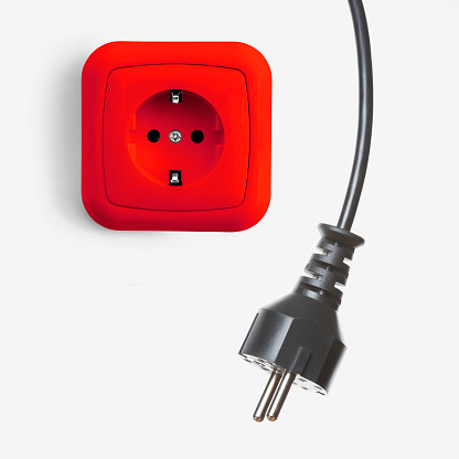 Red outlet with electric plug on white background