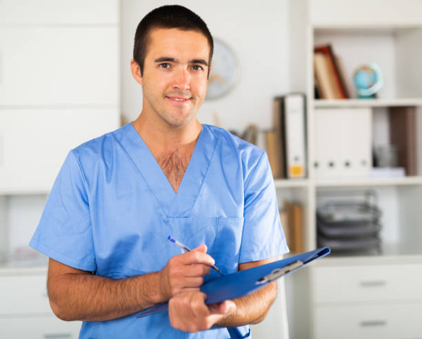 istock Positive latino doctor with folder of documents at office 1256250607