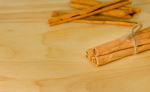 istock Group of cinnamon sticks spice on wooden board 1256250627