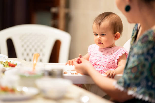 istock Parent feeding their little baby 1256251547