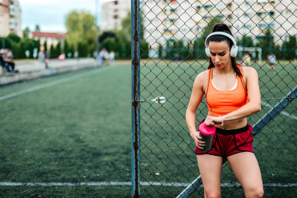 istock Woman athlete drinking water 1256253456