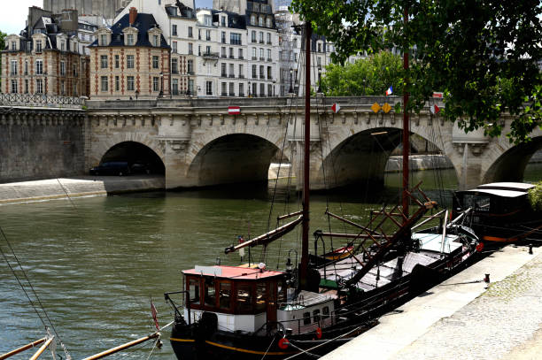 istock Old boat on the Seine river with a bridge in the background 1256253469