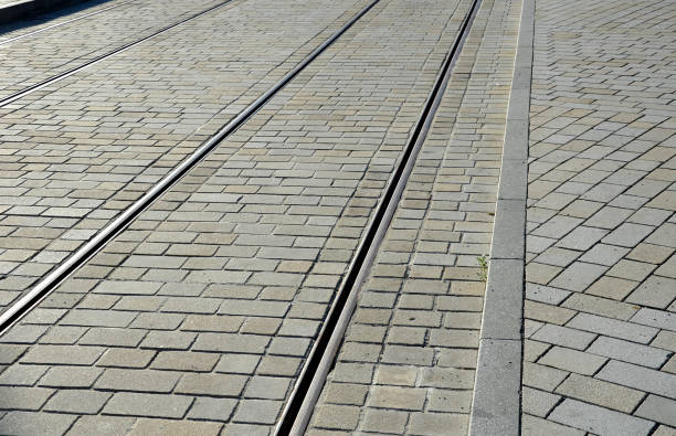 istock tram tracks in smooth cobblestone pavement light color gray brown beige granite 1256254707