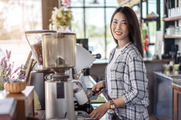 istock woman preparing coffee with machine in cafe 1256262396