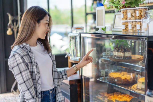 istock woman choosing cake in a cafe 1256262399