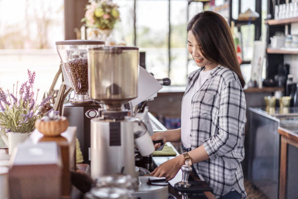istock woman preparing coffee with machine in cafe 1256262405