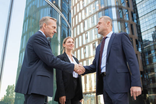 istock Confident middle-aged businessmen greeting each other 1256263951