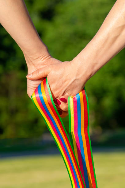 istock Women hold pride LGBT ribbon 1256264004