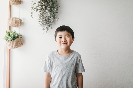 Portrait of Asian kid relaxed at home.