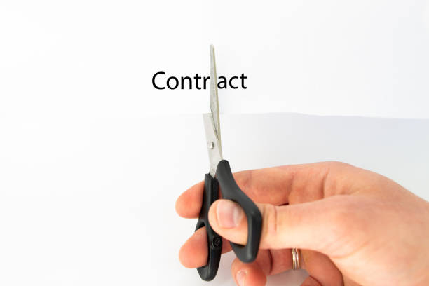 istock scissors in the hands of a man and a white sheet 1256265171